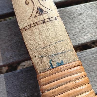Hand carved two faced Native American head archery decorative bow with arrows.