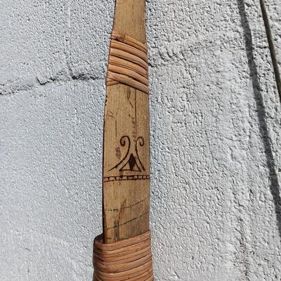 Hand carved two faced Native American head archery decorative bow with arrows.