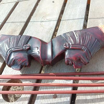 Hand carved two faced Native American head archery decorative bow with arrows.