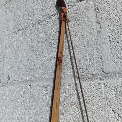 Hand carved two faced Native American head archery decorative bow with arrows.