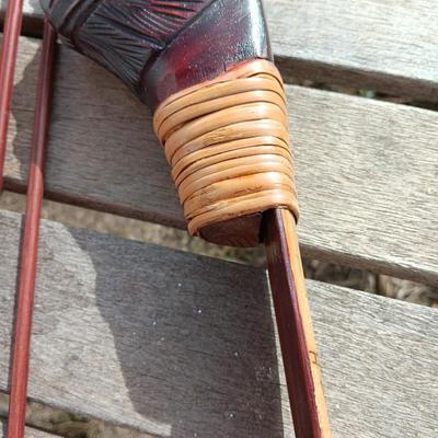 Hand carved two faced Native American head archery decorative bow with arrows.