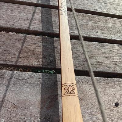 Hand carved two faced Native American head archery decorative bow with arrows.