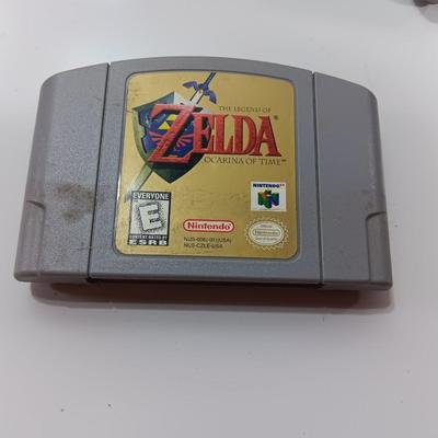 Nintendo 64 with controllers, Zelda game, and cords