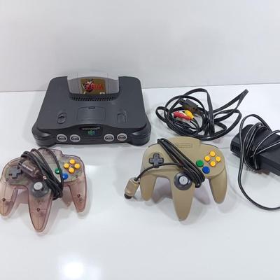 Nintendo 64 with controllers, Zelda game, and cords
