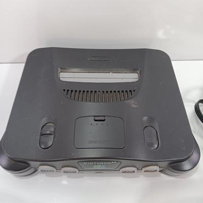 Nintendo 64 with controllers, Zelda game, and cords