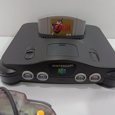 Nintendo 64 with controllers, Zelda game, and cords