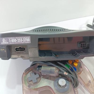 Nintendo 64 with controllers, Zelda game, and cords