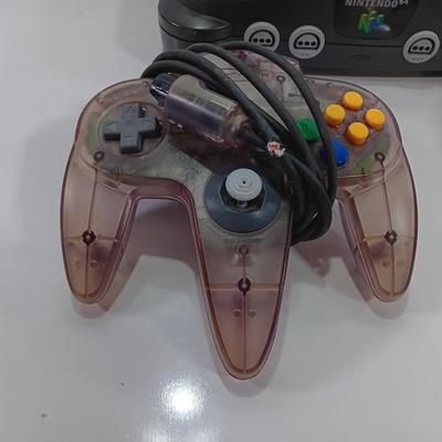 Nintendo 64 with controllers, Zelda game, and cords