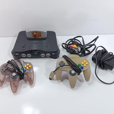 Nintendo 64 with controllers, Zelda game, and cords