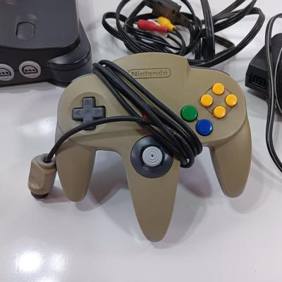 Nintendo 64 with controllers, Zelda game, and cords