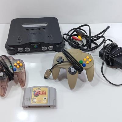 Nintendo 64 with controllers, Zelda game, and cords