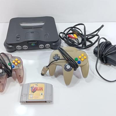 Nintendo 64 with controllers, Zelda game, and cords