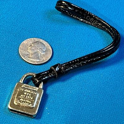 LIZ CLAIBORNE GOLD TONE PURSE TAG WITH BLACK STRAP