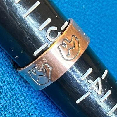 COPPER RING WITH INCISED BEAR AND ARROW SYMBOL AROUND BAND