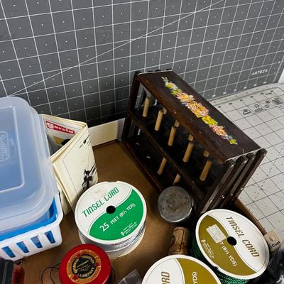 Box full of Fishing Related Items: Chenille, Hooks, Yarn, Reel 