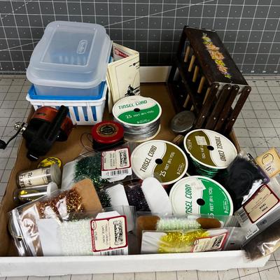 Box full of Fishing Related Items: Chenille, Hooks, Yarn, Reel 
