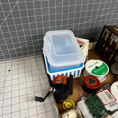 Box full of Fishing Related Items: Chenille, Hooks, Yarn, Reel 