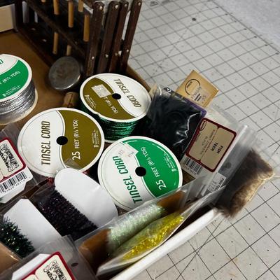 Box full of Fishing Related Items: Chenille, Hooks, Yarn, Reel 
