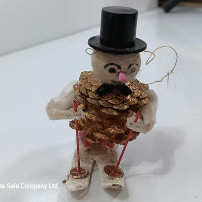 Antique pinecone Snow man skier
