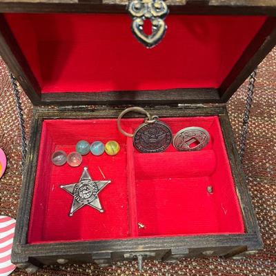 Small jewelry box with marbles, patches and pins