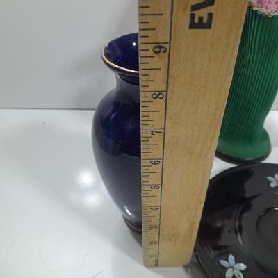Oriental doll with a vase and a decorative plate