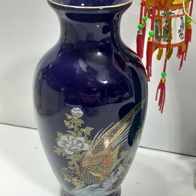 Oriental doll with a vase and a decorative plate