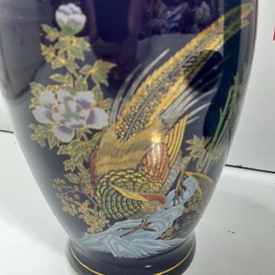 Oriental doll with a vase and a decorative plate