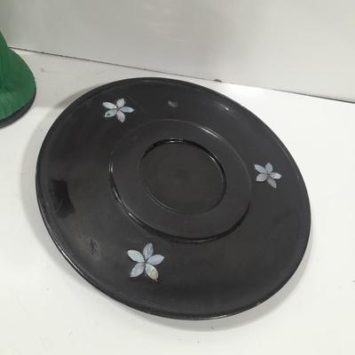 Oriental doll with a vase and a decorative plate