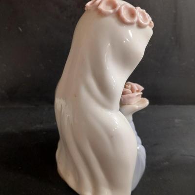 Porcelain praying hands with girl with flowers in her hands