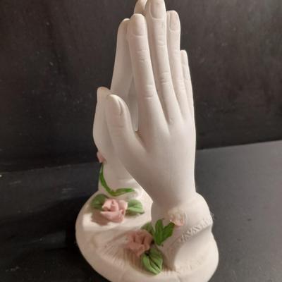 Porcelain praying hands with girl with flowers in her hands