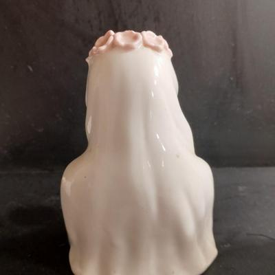 Porcelain praying hands with girl with flowers in her hands