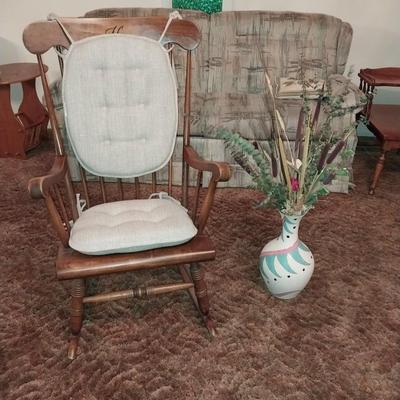 ROCKING CHAIR WITH NICE CUSHIONS AND A VASE W/FOLIAGE