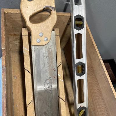 Saw and level in vintage crate