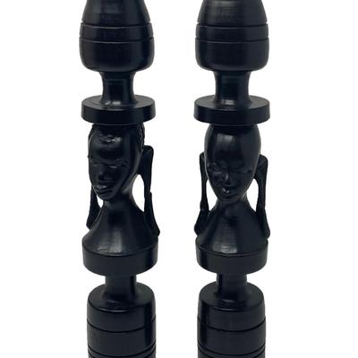 2 matching candle sticks with facial carving