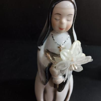 Porcelain religious figures -- Nunn -- girl praying with sheep -- and lady holding child.