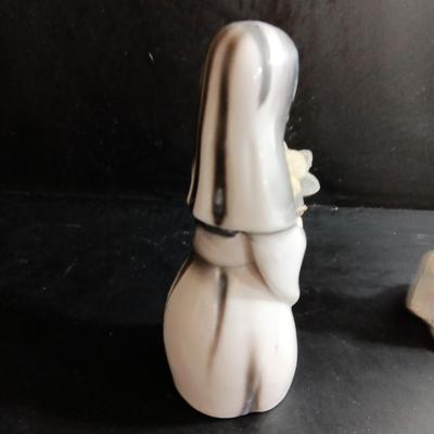 Porcelain religious figures -- Nunn -- girl praying with sheep -- and lady holding child.