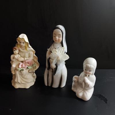Porcelain religious figures -- Nunn -- girl praying with sheep -- and lady holding child.