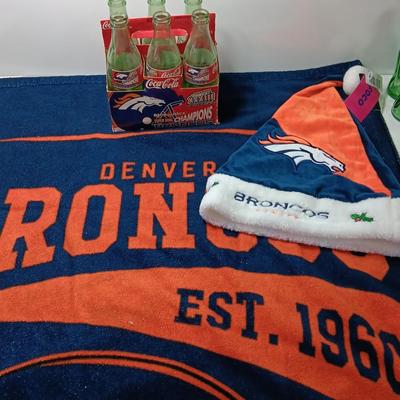 Denver Bronco's Back-to-Back Superbowl coca cola bottles in case with a Bronco's towel and Christmas hat