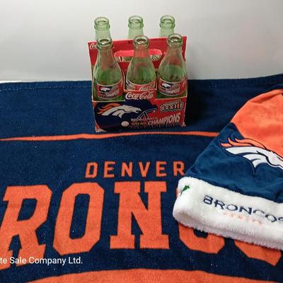Denver Bronco's Back-to-Back Superbowl coca cola bottles in case with a Bronco's towel and Christmas hat