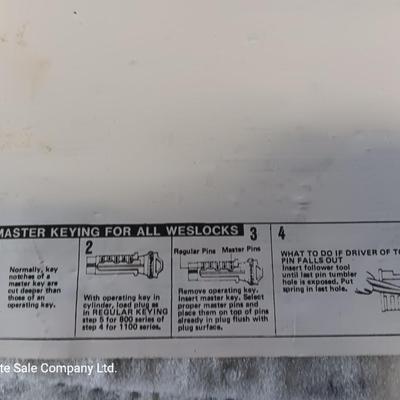Metal box full of Wesklock keying kit hardware