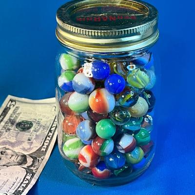 HALF PINT JAR FULL OF ASSORTED MARBLES