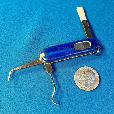 AVON SMALL POCKET KNIFE-LIKE MULTI-TOOL: TWEEZERS, MIRROR, BRUSH, PICK, ETC.