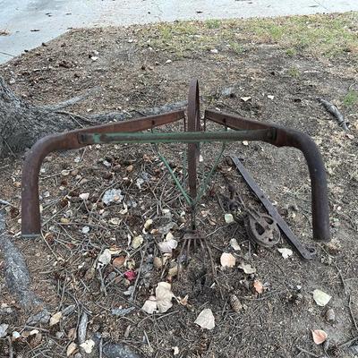 ANTIQUE IRON HAND CULTIVATOR WITH AN OLD PULLEY