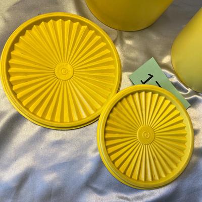 Yellow Tupperware canisters