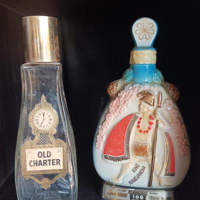 Old Charter bottle and Jim Beam King Kamehameha Decanter