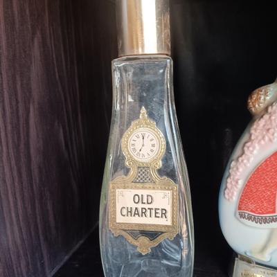 Old Charter bottle and Jim Beam King Kamehameha Decanter
