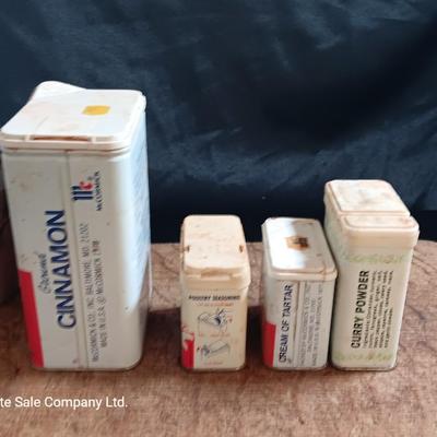 Primitive wooden cutting board with tin spice containers and aluminum salt & pepper shakers