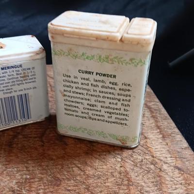 Primitive wooden cutting board with tin spice containers and aluminum salt & pepper shakers