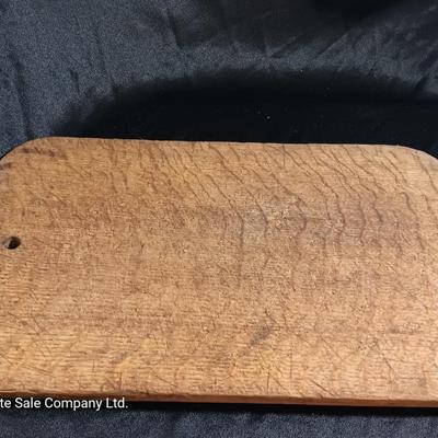 Primitive wooden cutting board with tin spice containers and aluminum salt & pepper shakers