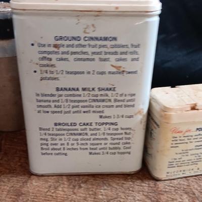 Primitive wooden cutting board with tin spice containers and aluminum salt & pepper shakers